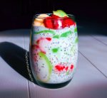 Glass of Coconut Lime Chia Pudding with coconut milk, strawberries, avocado, lime, chia seeds and banana