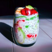 Glass of Coconut Lime Chia Pudding with coconut milk, strawberries, avocado, lime, chia seeds and banana