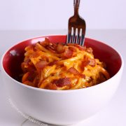 fork standing up in bowl of spaghetti carbonara with butternut squash noodles