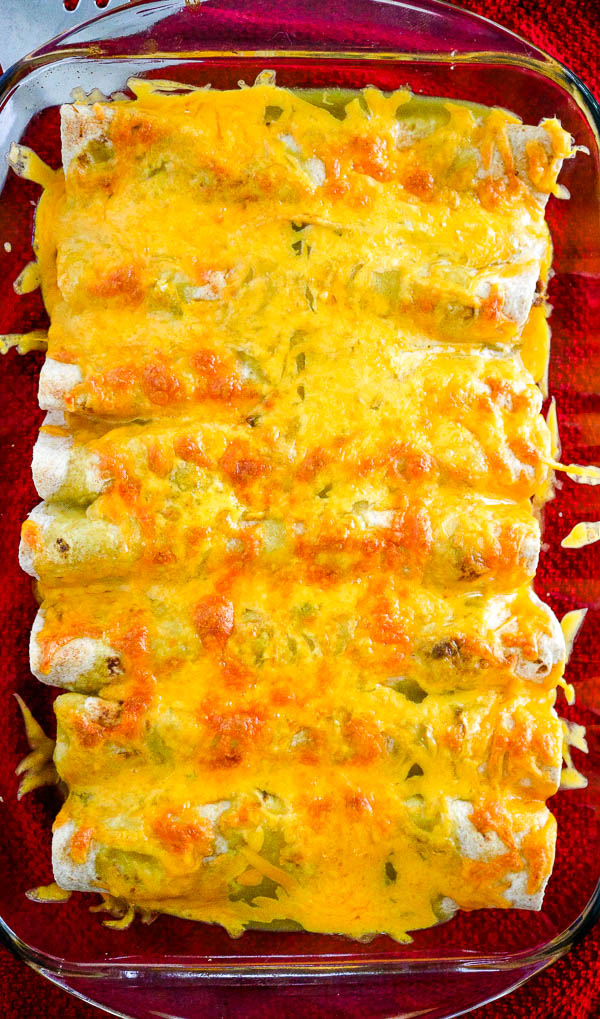 overhead view of 8 smothered burritos topped with cheese