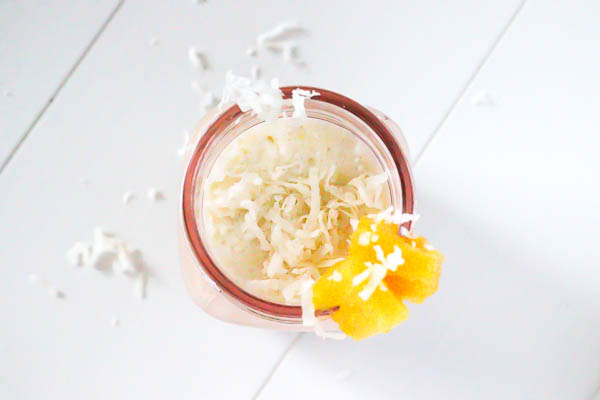 Healthy Pina Colada Chia Pudding in glass jar blended as a smoothie overhead look