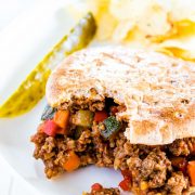 sloppy joe sandwich on a plate with bite taken