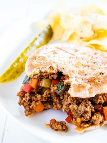 sloppy joe sandwich on a plate with bite taken