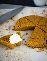 pumpkin scone bitten into with whipped cream