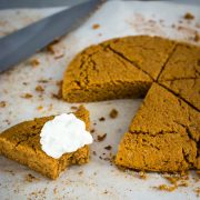 pumpkin scone bitten into with whipped cream