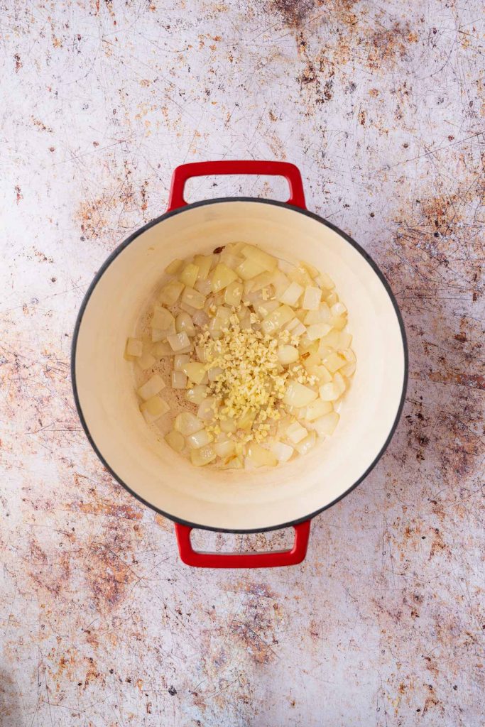 Chopped garlic and ginger added to pot with chopped onions.