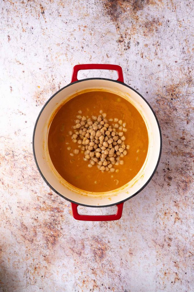 Chickpeas in soup base in pot.