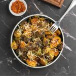 brussel sprouts in bowl garnished with parmesan cheese.